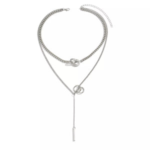 Silver layered Y-shaped pendant necklace with interlocking rings and bar detail.