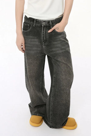 Faded wash dark palazzo jeans for him with a relaxed fit and visible stitching.