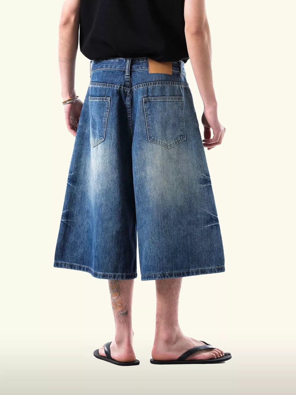 Relaxed fit light blue denim capris with a wide leg and distressed details.