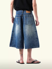 Relaxed fit light blue denim capris with a wide leg and distressed details.