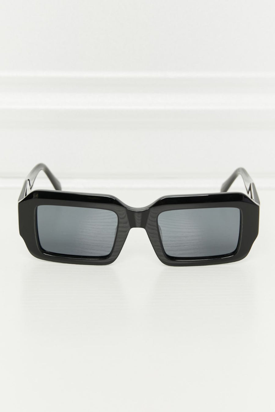 Black geometric frame polarized sunglasses with acetate material.