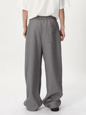 Plaid wide-leg relaxed fit pants in grey with adjustable waist, shown from the back.