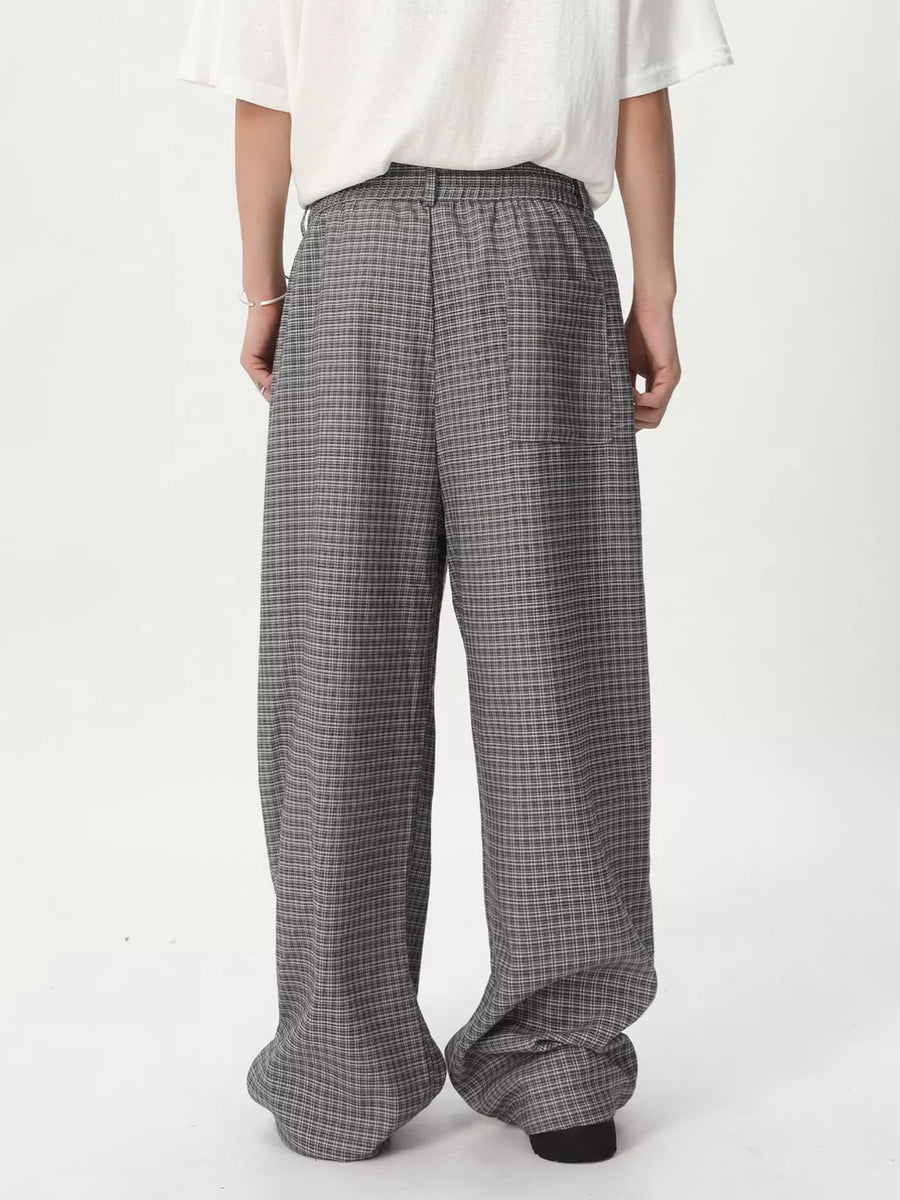 Plaid wide-leg relaxed fit pants in grey with adjustable waist, shown from the back.