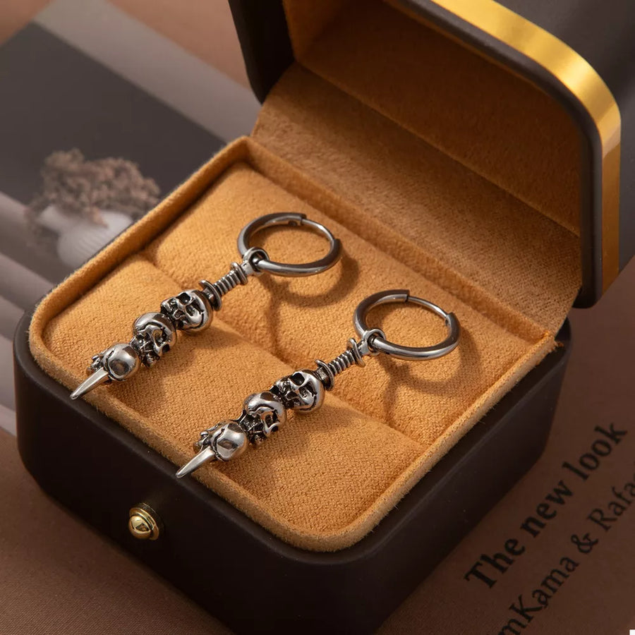 Silver earrings featuring skull charms and skull motif