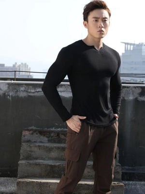 Black ribbed long sleeve t-shirt with a V-neck and notched detail.