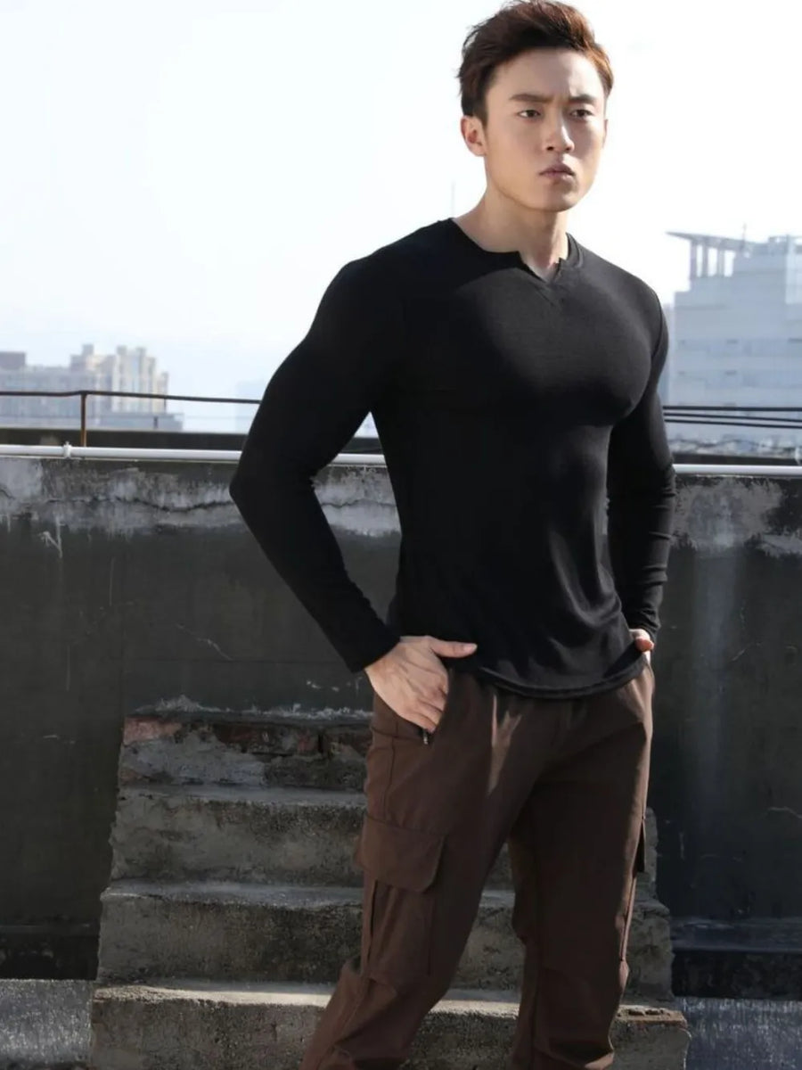 Black ribbed long sleeve t-shirt with a V-neck and notched detail.
