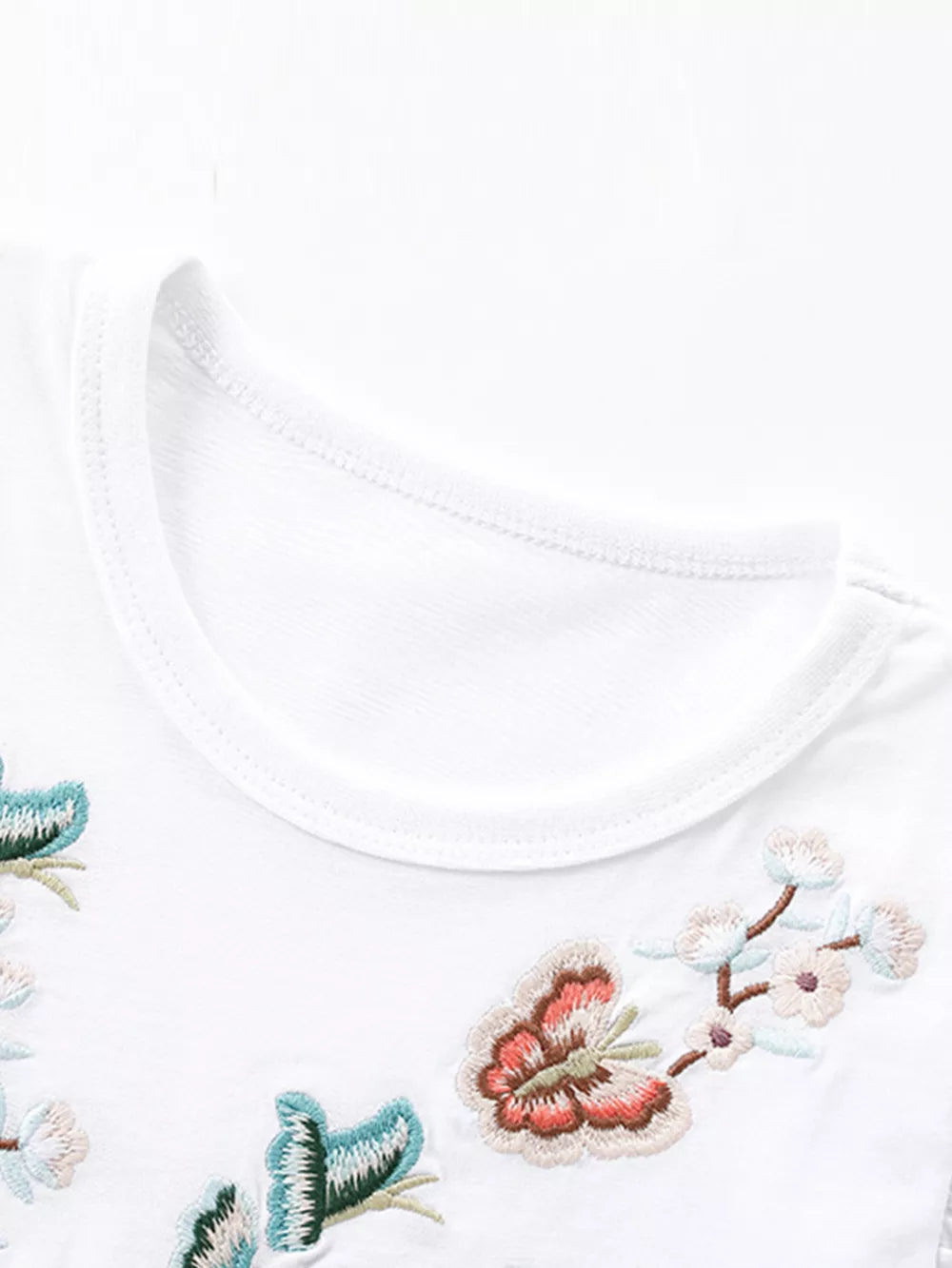 White cotton baby dress with embroidered butterflies and flowers detail
