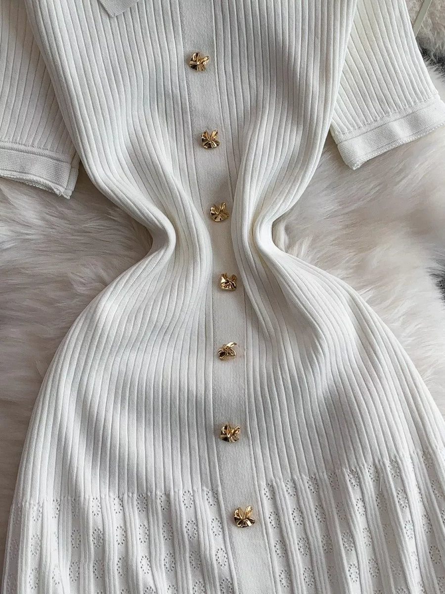 White ribbed knit midi dress with gold butterfly button detail and eyelet hem.