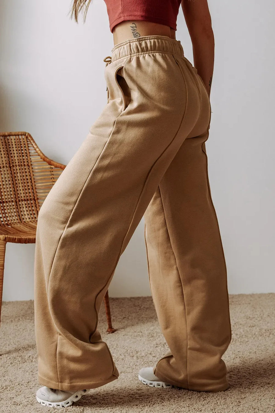Tan relaxed fit sweatpants with wide legs and seam detail.