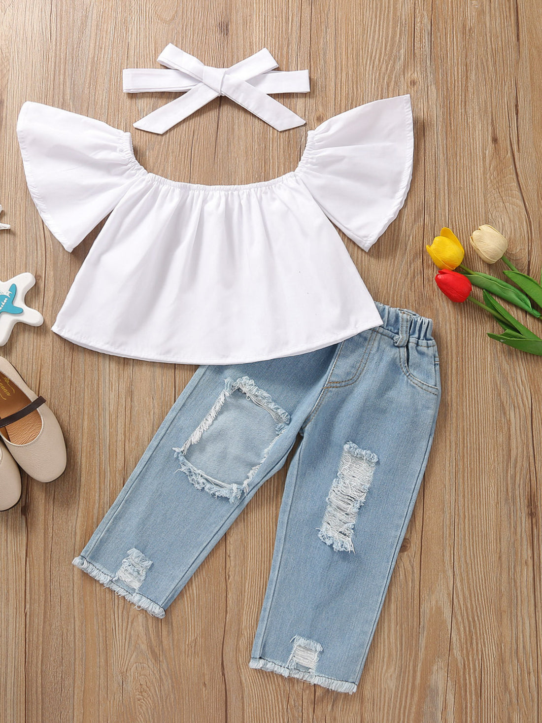 Toddler white off-shoulder ruffle top and distressed light wash denim jeans set with headband.