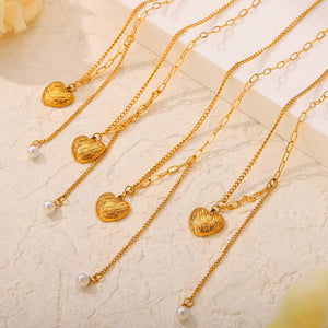 Gold textured heart and pearl drop necklaces, layered chains, elegant jewelry.