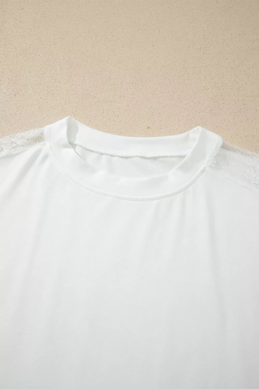 White long sleeve shirt with crew neck and delicate lace shoulder detail