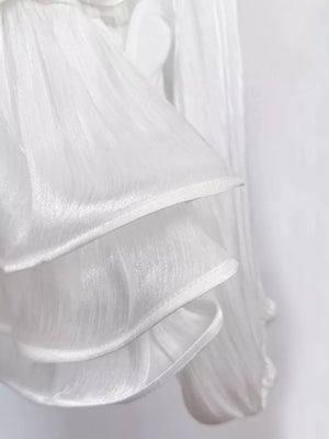 White ruffled mini dress with corset waist detail, sheer fabric.