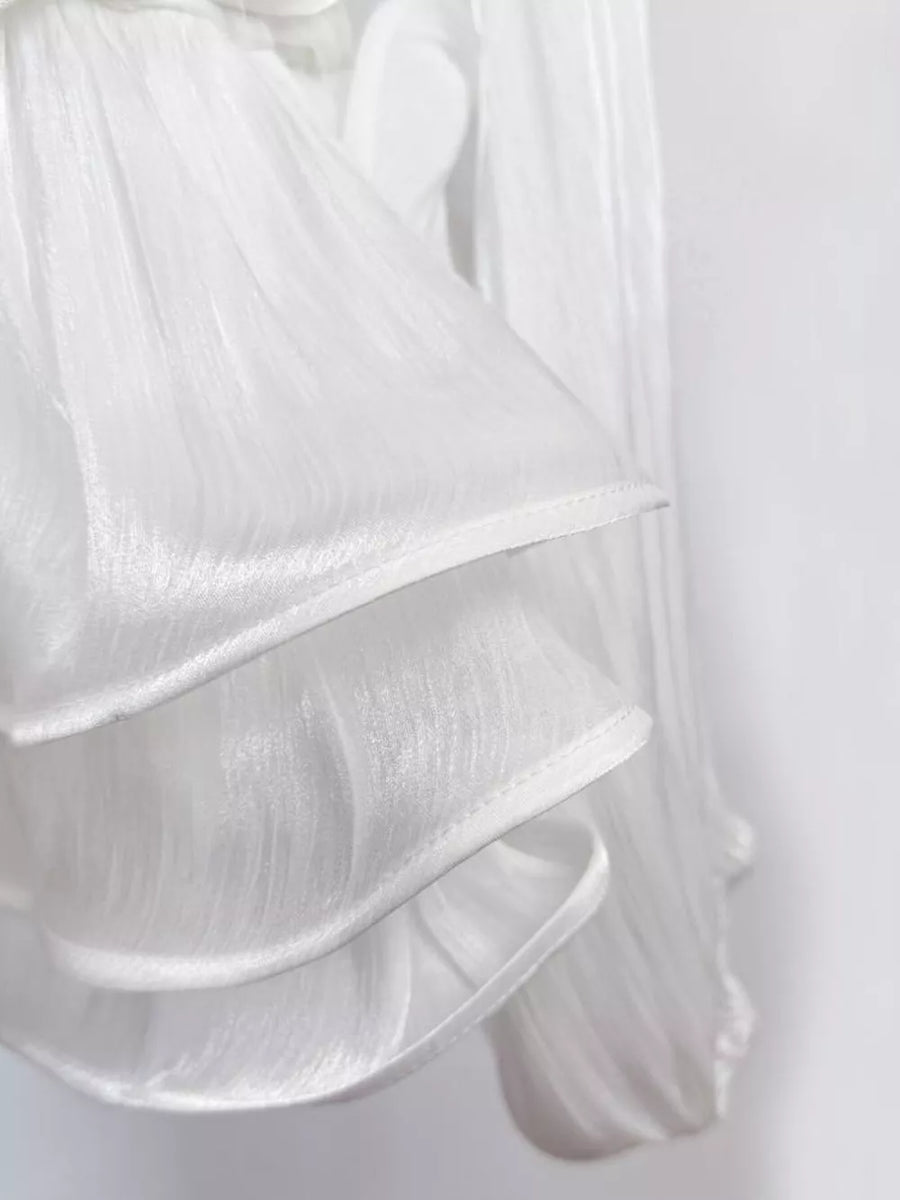 White ruffled mini dress with corset waist detail, sheer fabric.