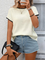 Off-white ribbed knit sweater with black contrast trim short sleeves and neckline.