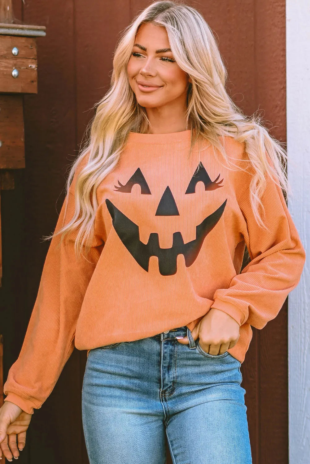 Caramel corduroy sweatshirt with jack-o'-lantern graphic and long sleeves.