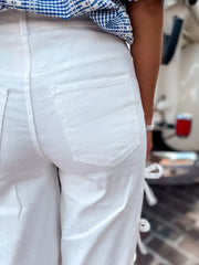 White maternity wide-leg trousers with bow details on the side.