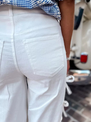 White maternity wide-leg trousers with bow details on the side.