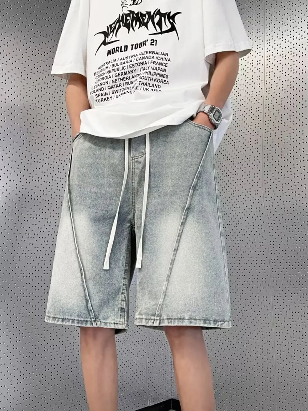 Light blue denim shorts with drawstring and diagonal seam detail for men.