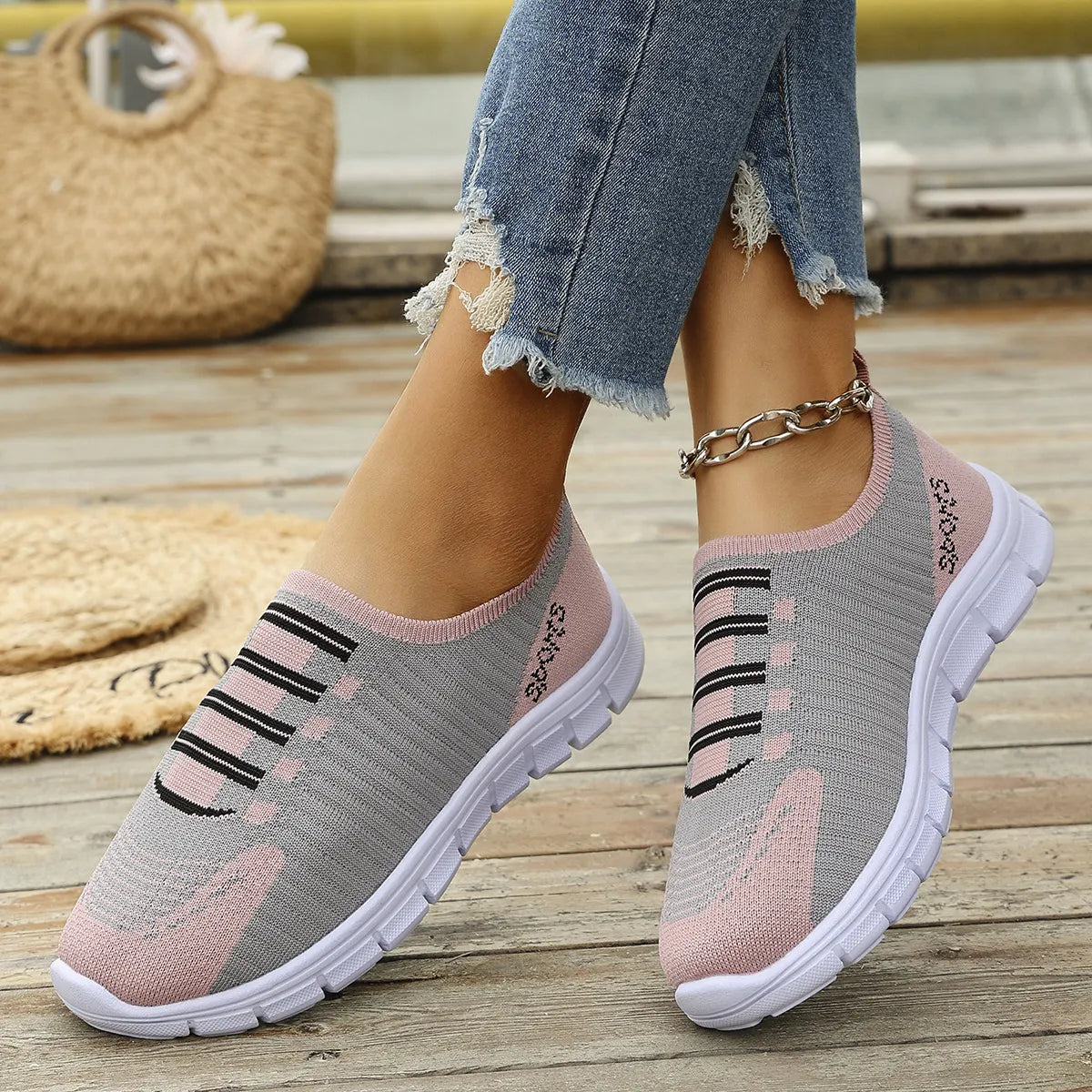 Ribbed knit slip-on sneakers in gray and dusty pink with black stripe detail.