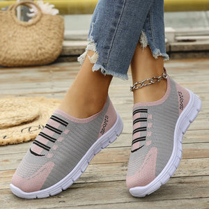 Ribbed knit slip-on sneakers in gray and dusty pink with black stripe detail.