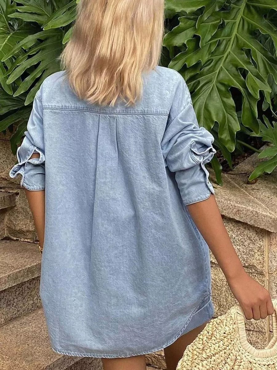 Light blue denim shirt with tie-detail sleeves and back pleats.
