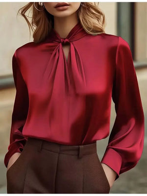 Red satin blouse with tie-neck detail and cutout, long sleeves.