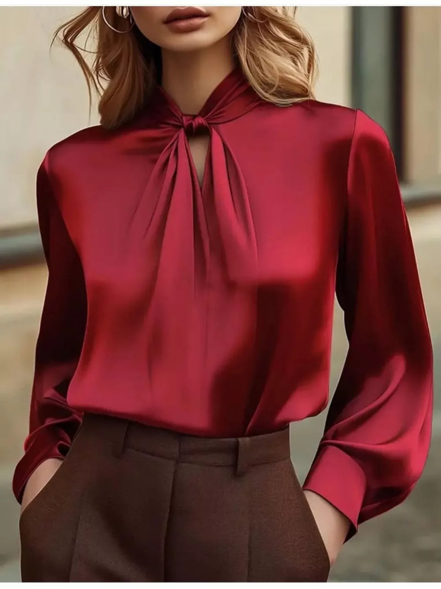 Red satin blouse with tie-neck detail and cutout, long sleeves.