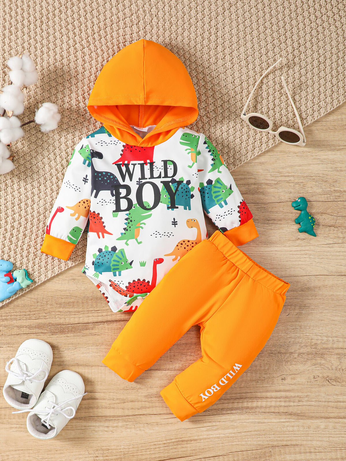 white bodysuit with dinosaur-print and hooded