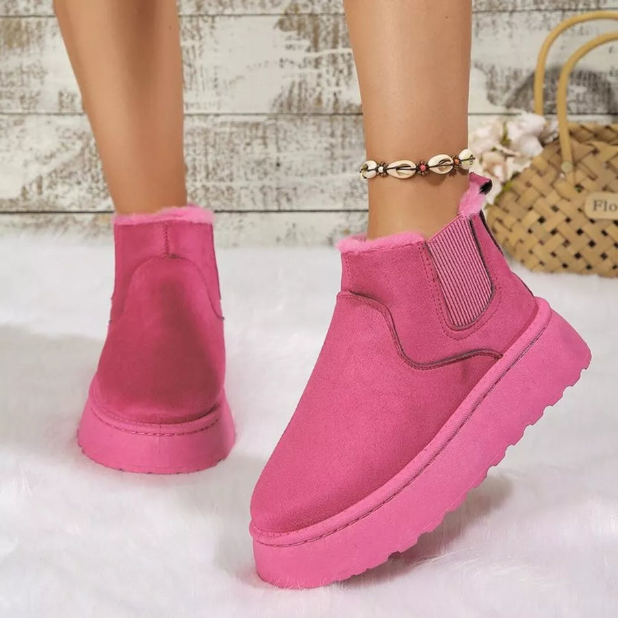 Hot Pink suede round toe platform ankle boots with faux fur lining.