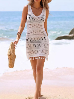 White crochet cover-up dress with openwork pattern and tassel hem, V-neck, sleeveless.