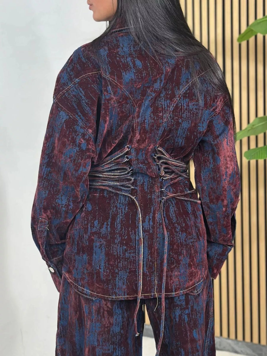 Burgundy denim jacket and pants set with lace-up back detail and distressed pattern