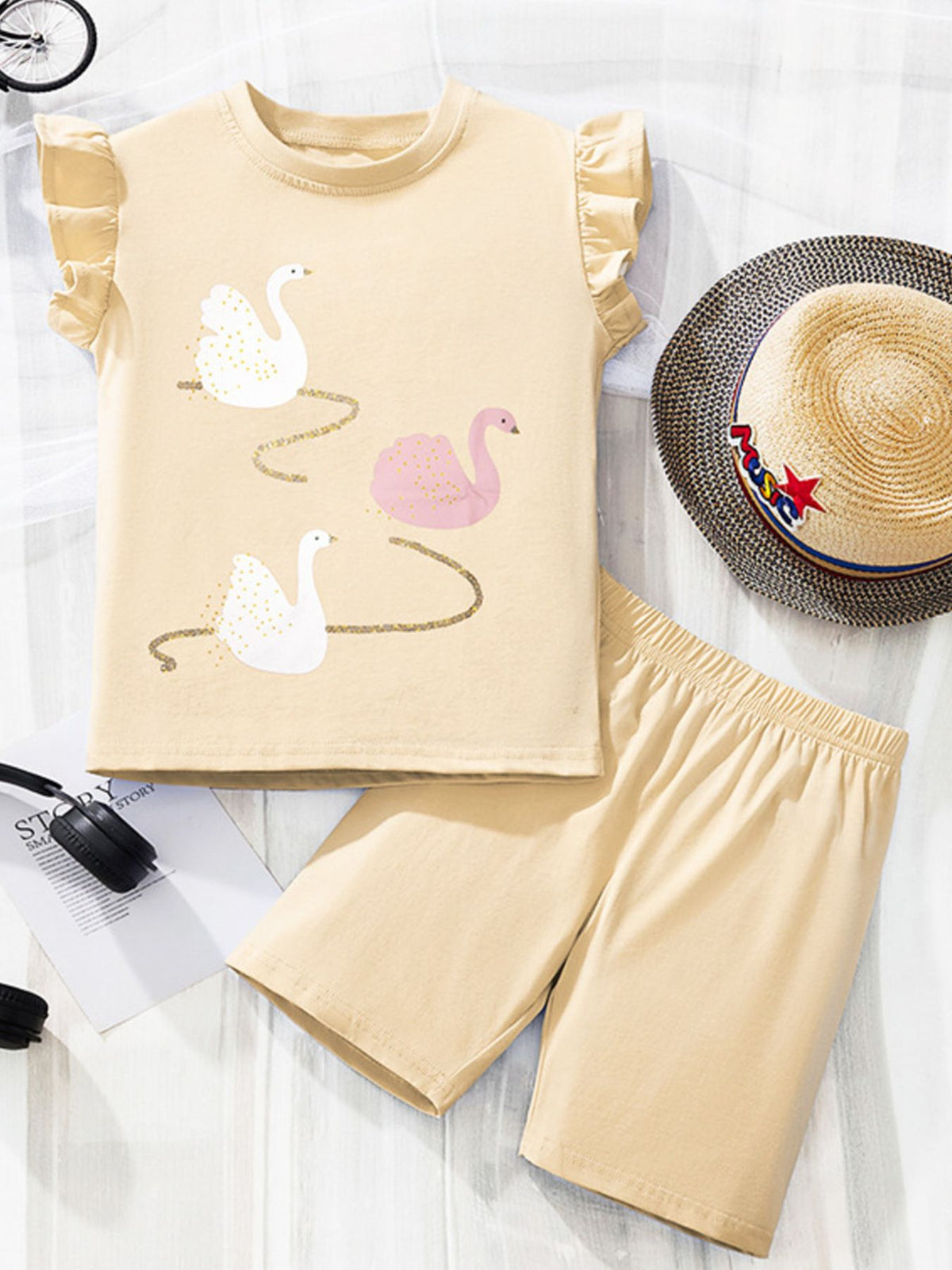 Girls' beige cotton set with swan print and ruffle sleeves.
