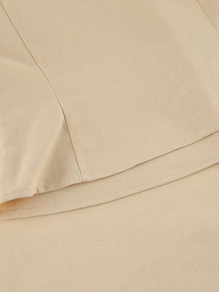two-piece set in light beige with one-shoulder and sleeveless