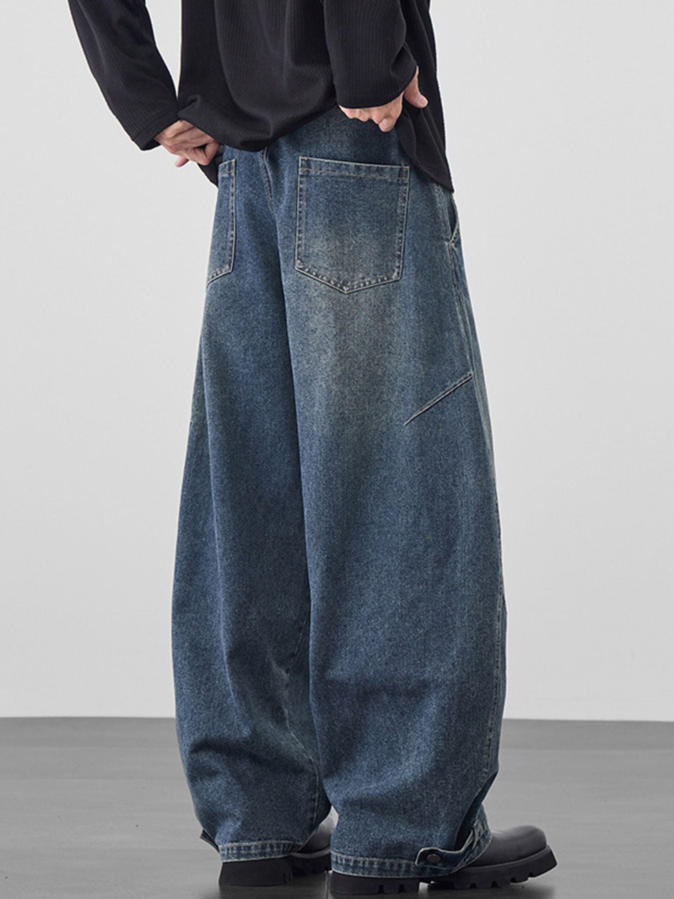 Men's baggy jeans in medium wash cotton with cinched hems.