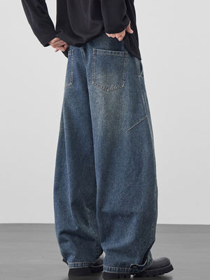 Men's baggy jeans in medium wash cotton with cinched hems.
