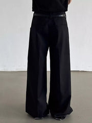 Black relaxed fit wide-leg dress pants with a belt and decorative trim.