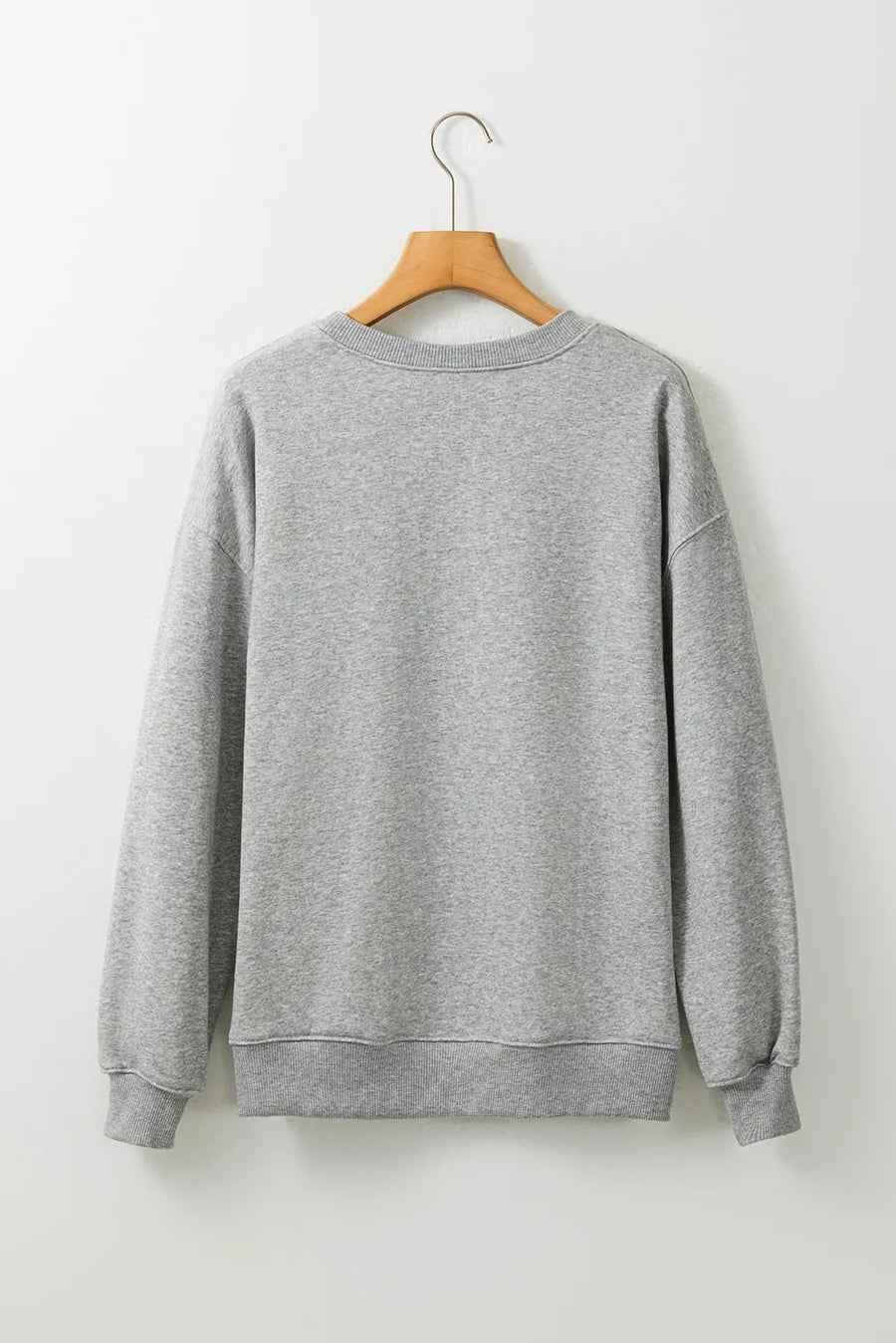 Gray crewneck sweatshirt with ribbed cuffs and hem, casual style.