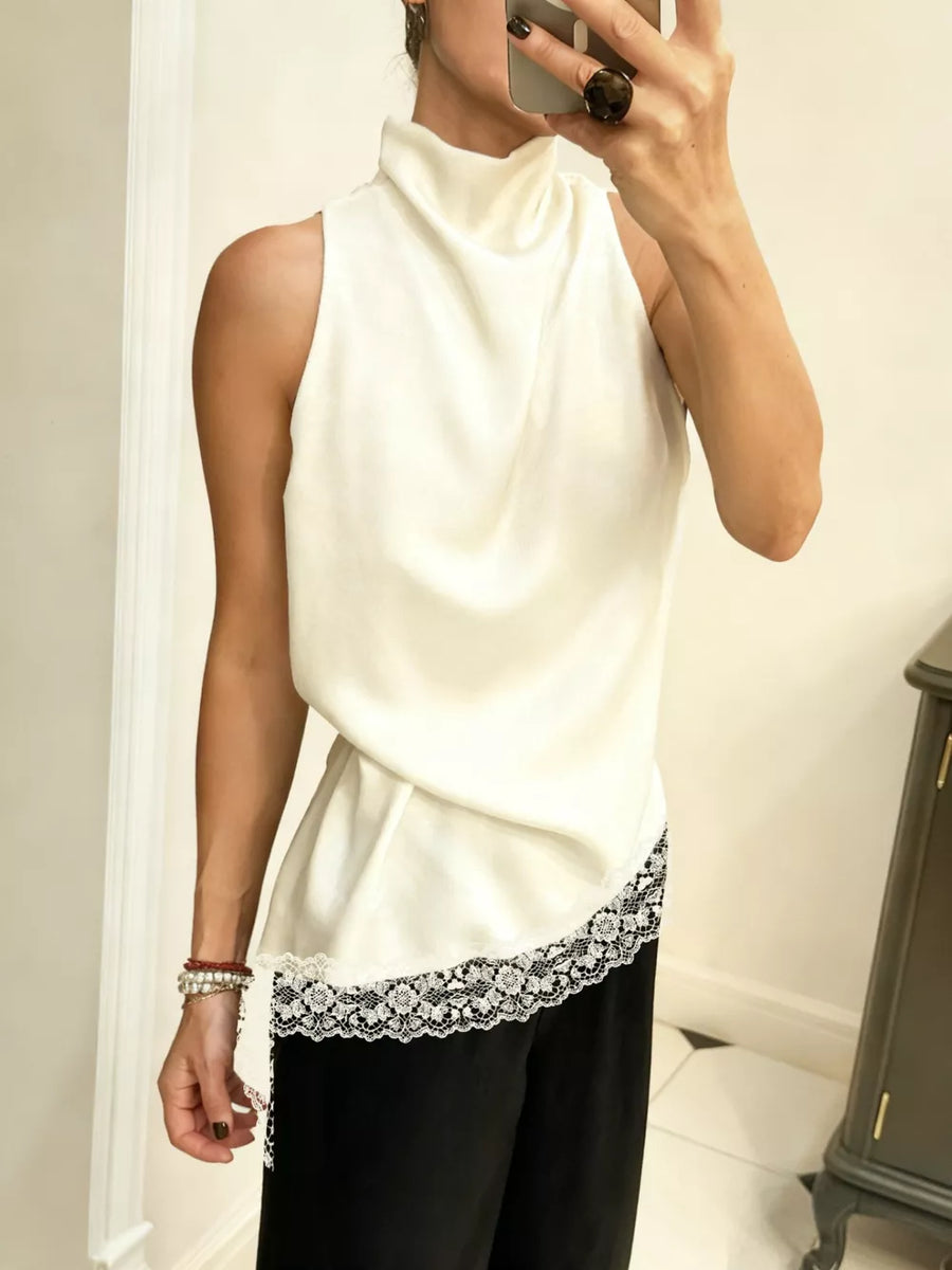 Ivory asymmetrical cami top with lace trim detail and cowl neck.