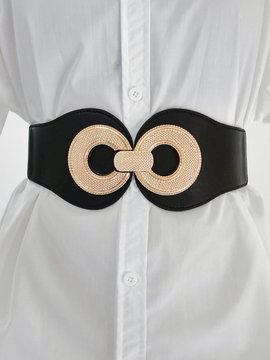 Black cincher belt with gold metalwork detail, worn over a white shirt.
