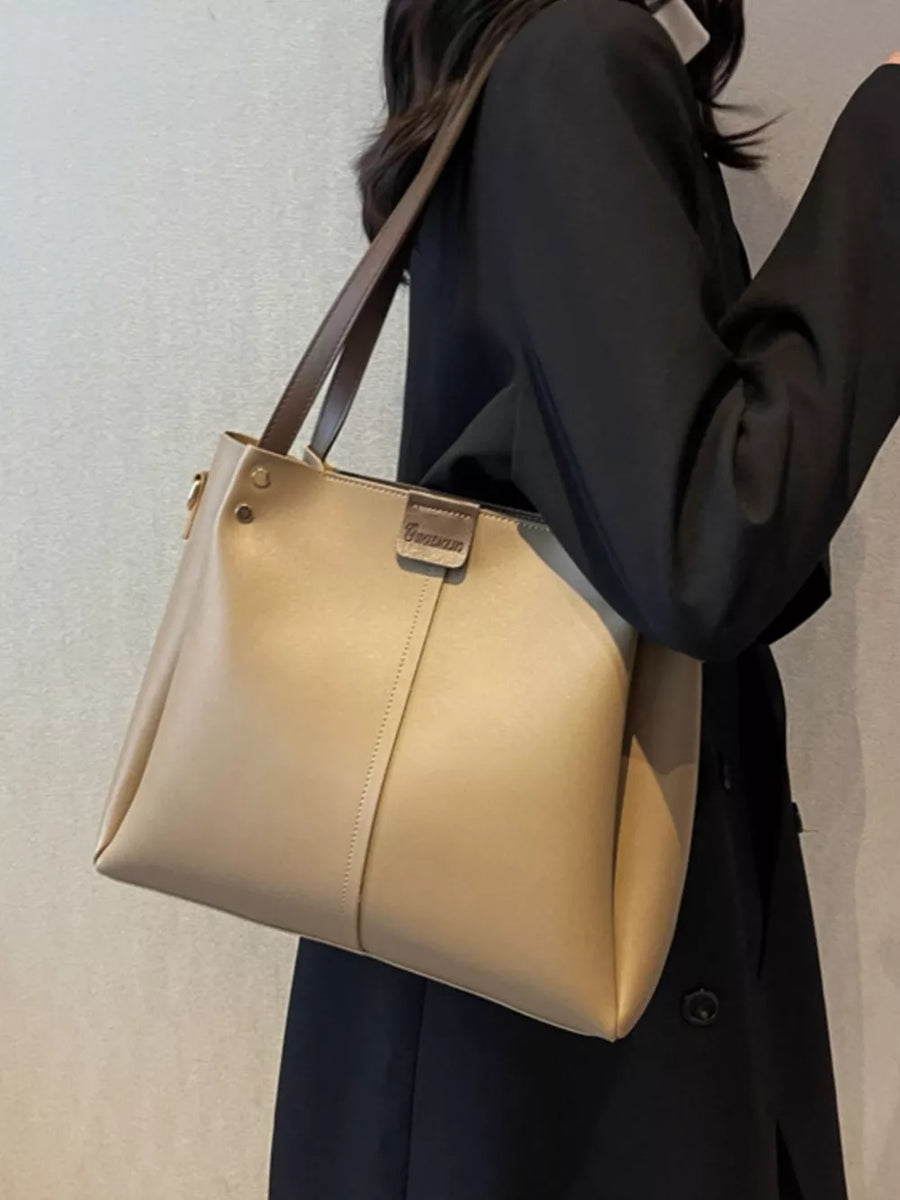 Khaki wide strap PU leather trapezoid handbag with detachable strap.