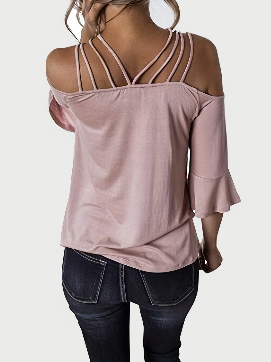 Blush pink blouson top with strappy shoulders and flared sleeves.