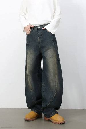 Dark wash denim balloon trousers with a relaxed fit and unique sculpted seams.