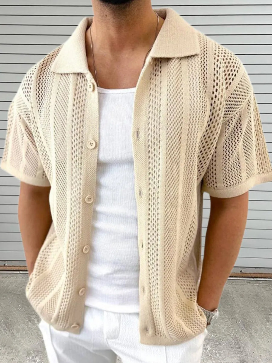 Beige open-knit resort shirt with short sleeves and button front, styled with a white tank top.