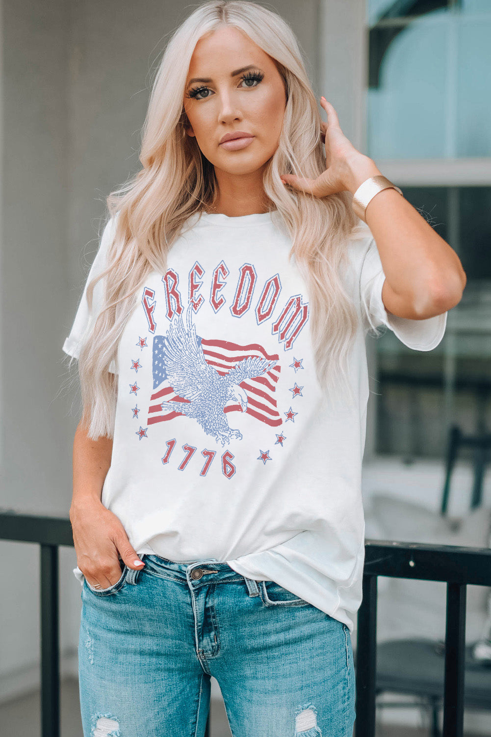 White graphic tee with eagle, American flag, and 1776 print