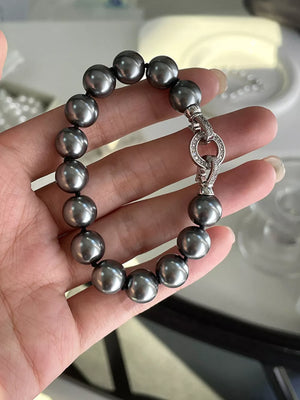 Dark gray beaded bracelet with clasp and cubic zirconia details