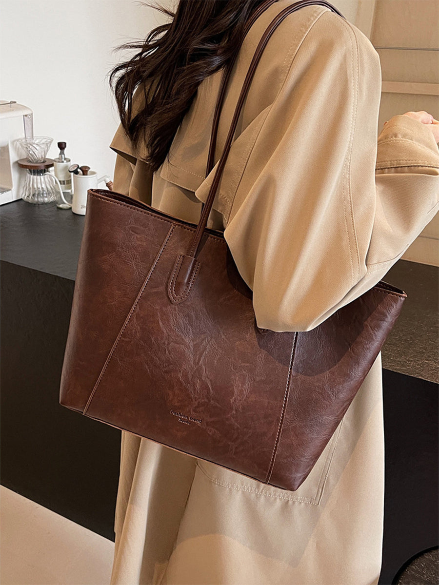 Premium crinkled pu leather tote bag in coffee brown with subtle texture and stitching detail.