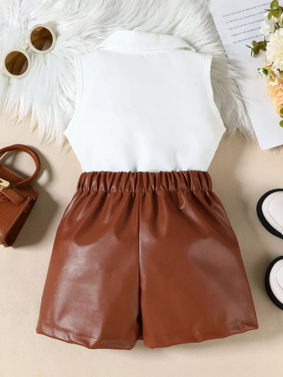 Brown faux leather shorts with elastic waist and white collared sleeveless top.