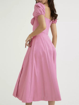 Pink puff sleeve tie front midi dress with a sweetheart neckline and full skirt.