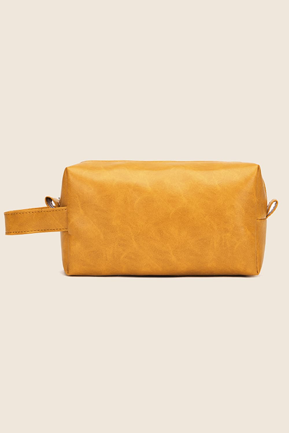 Textured faux leather travel case in caramel with a carry handle.